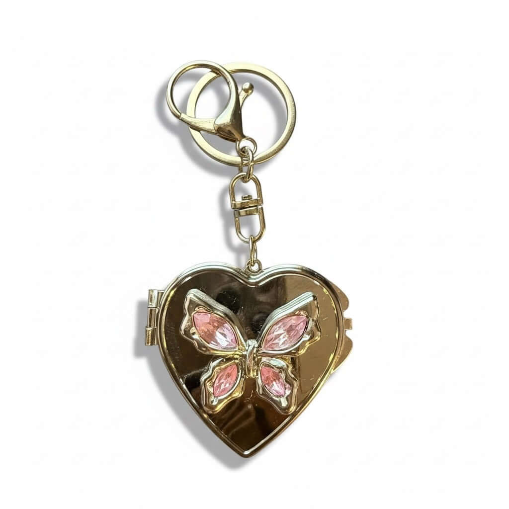Legacy Blush Butterfly Locket Charm in gold featuring a pink butterfly design and heart shape.