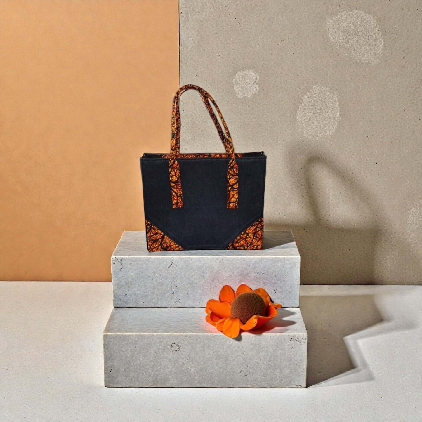 Iris Artisan Patterned Tote – Custom Handcrafted Fabric Tote Bag on display with vibrant accents and an orange flower.