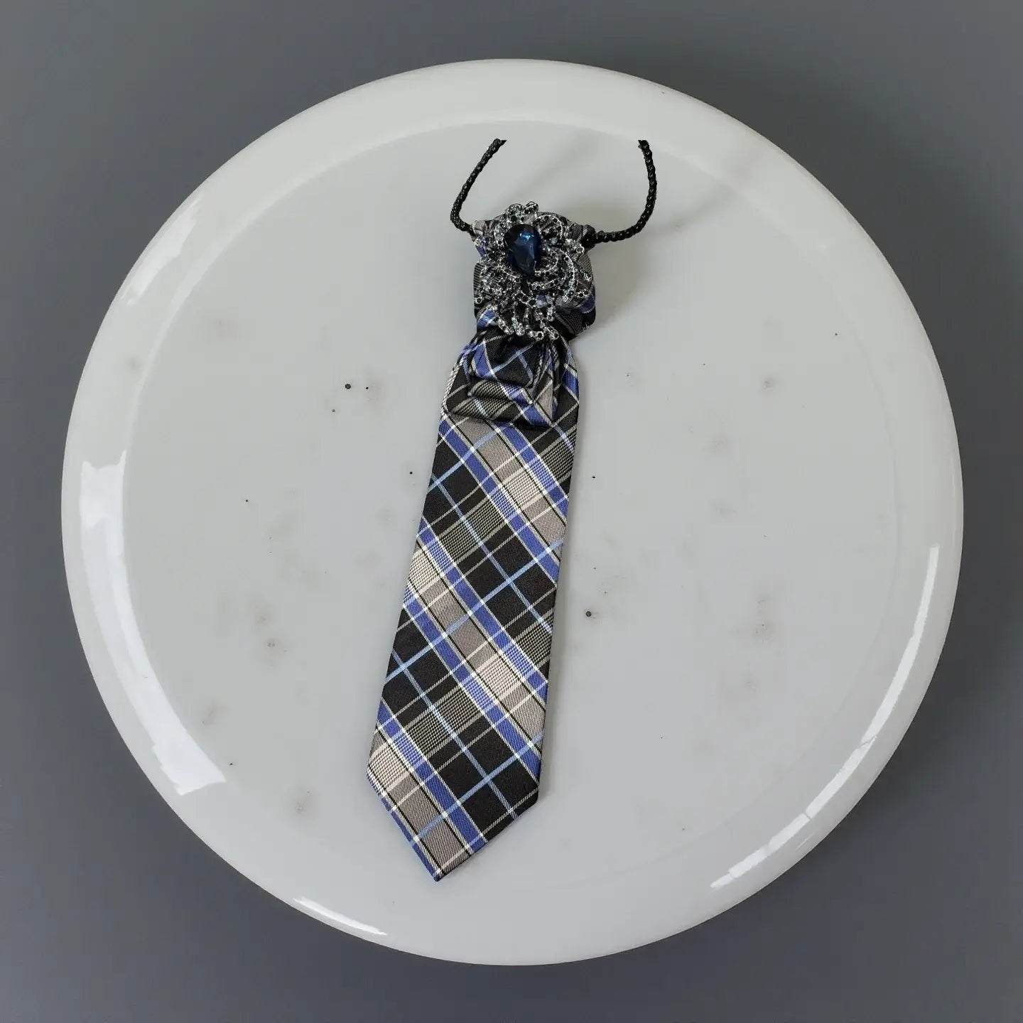 Sapphire Noir Statement Tie Necklace – Handcrafted One-of-One displayed on a white marble plate.