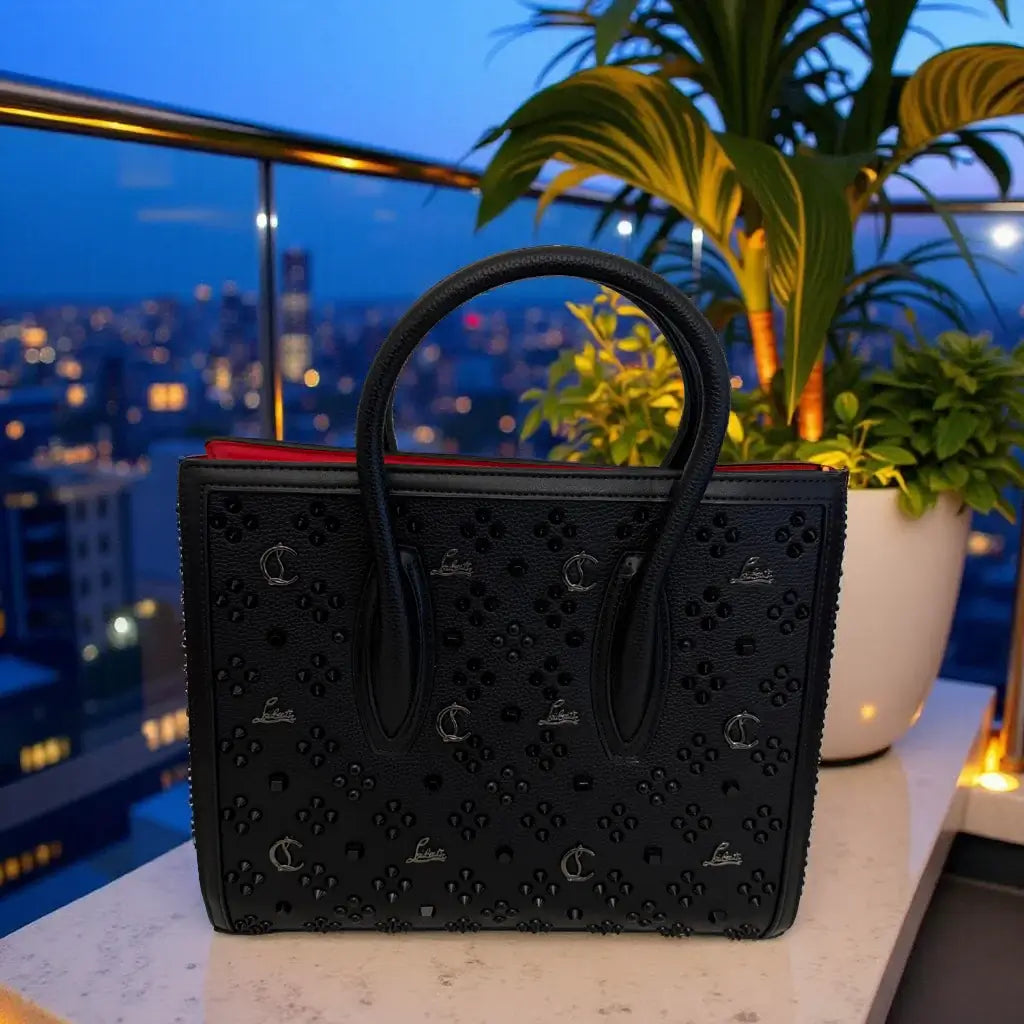Black and Silver Studded Luxe Handbag on display with a stunning city view at dusk.