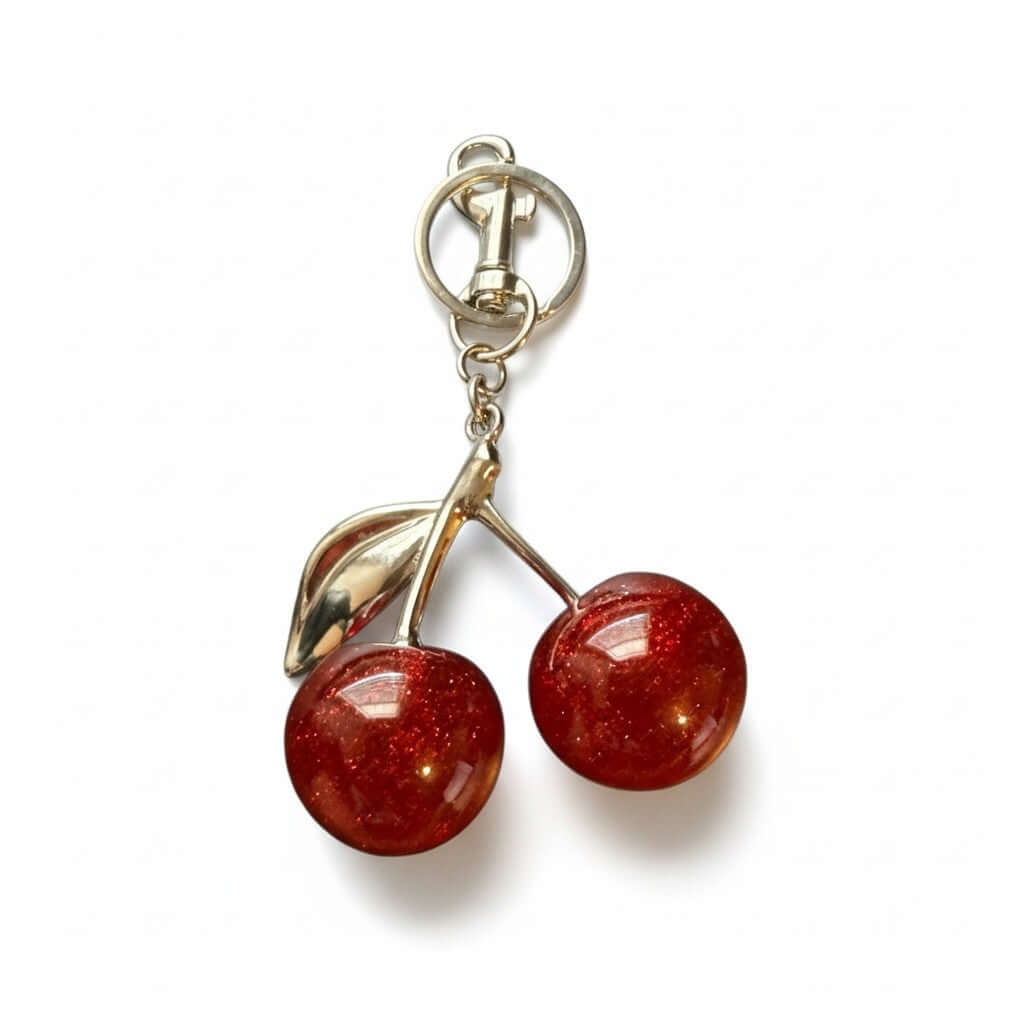 Legacy Ruby Cherry Charm featuring glossy deep-ruby cherries and gold detailing for a chic accessory.