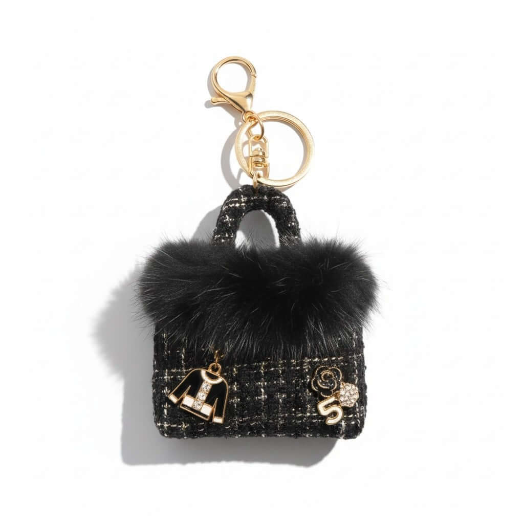 Legacy Noir Luxe Mini Charm featuring black faux fur, textured tweed, and gold enamel charms for a stylish accessory.
