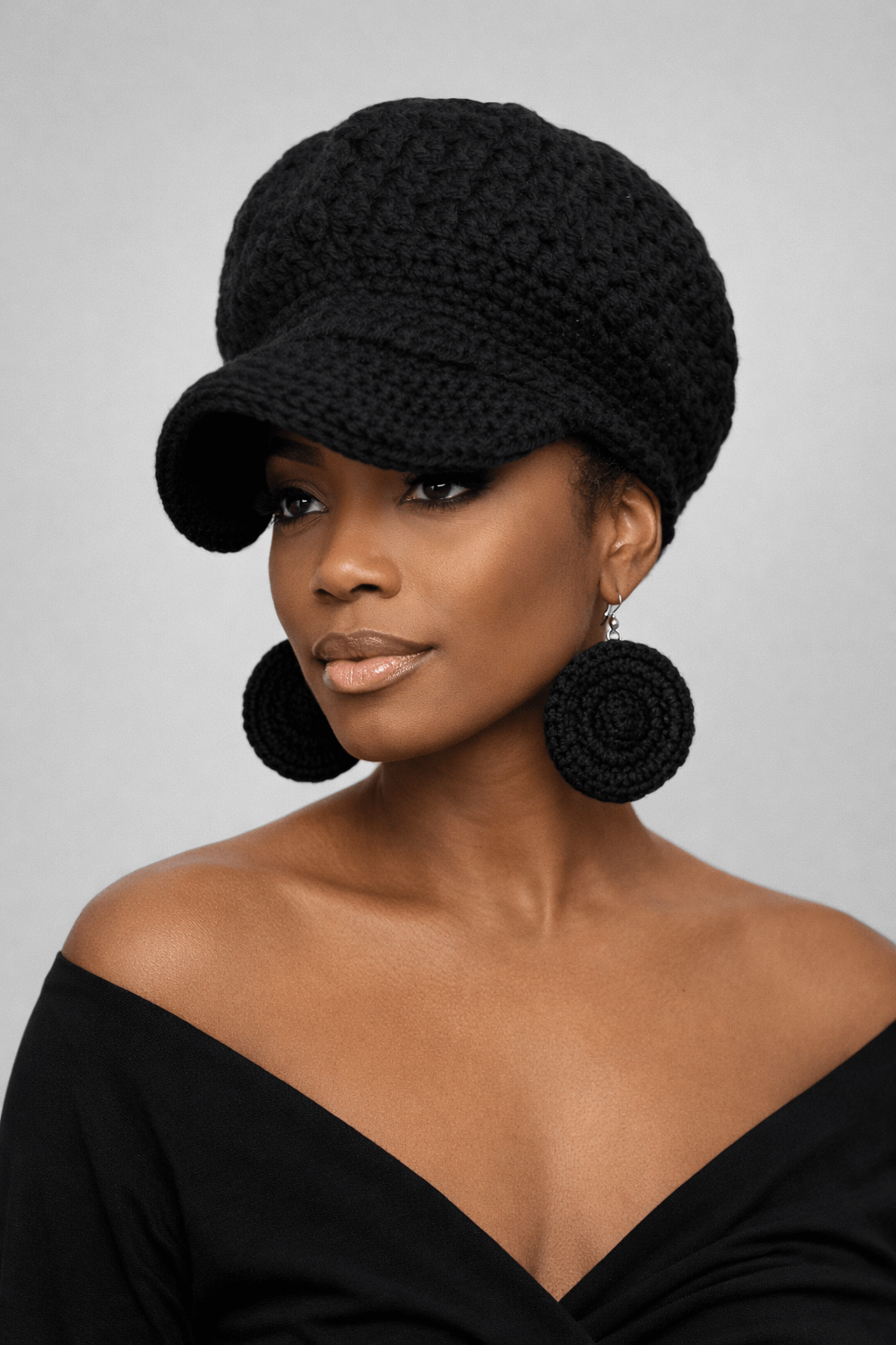 Blackstone Crochet Crown Set- One of One-Signature Texture showcased on a model wearing a knit cap and earrings.
