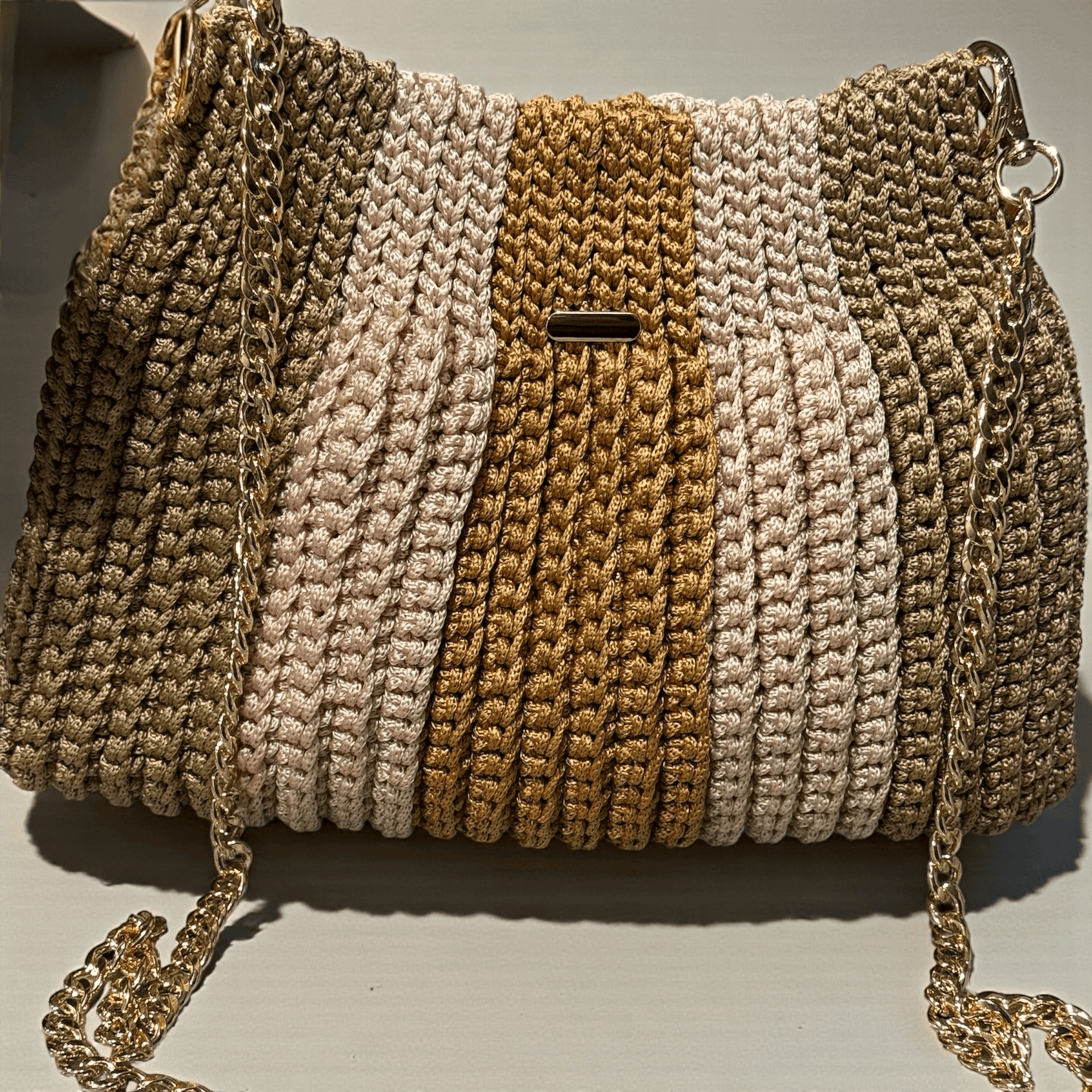Solara Handcrafted Crochet Chain Crossbody in neutral colors with gold-tone chain strap and textured design.