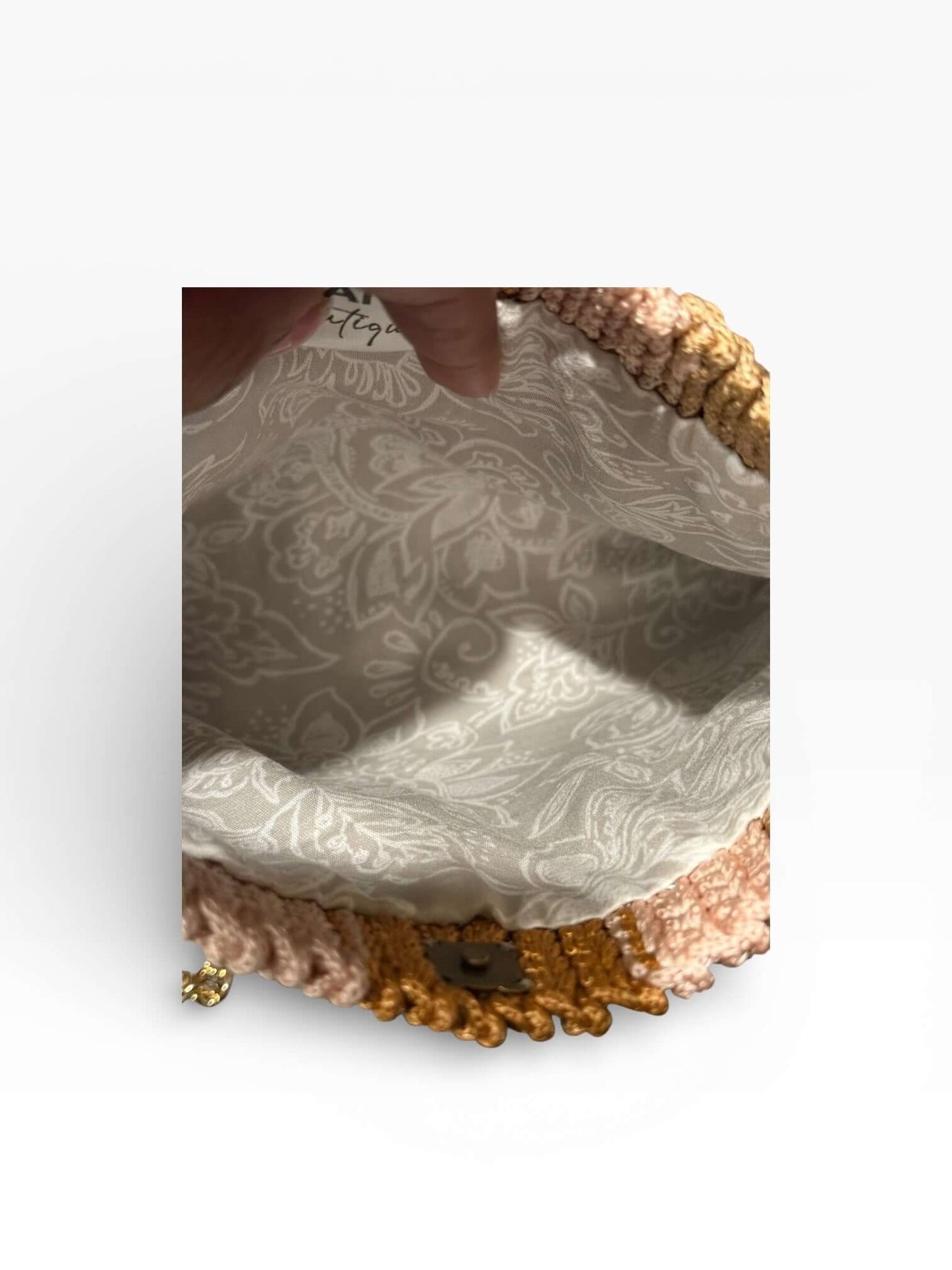 Interior view of the Solara Handcrafted Crochet Chain Crossbody showcasing its elegant lining and intricate crochet design.