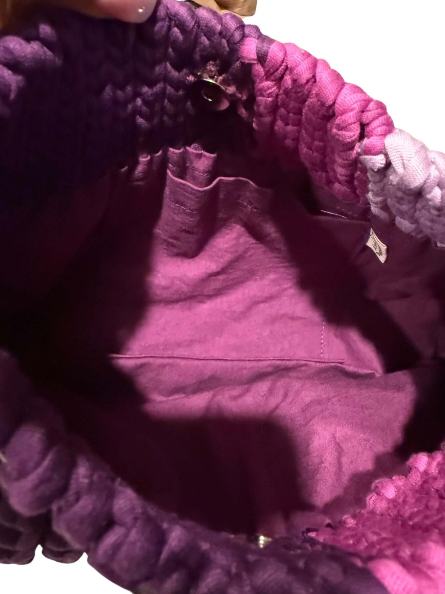 Interior view of the Amethyst Crochet Chain Bag showcasing smooth plum lining and discreet pocket for organization.