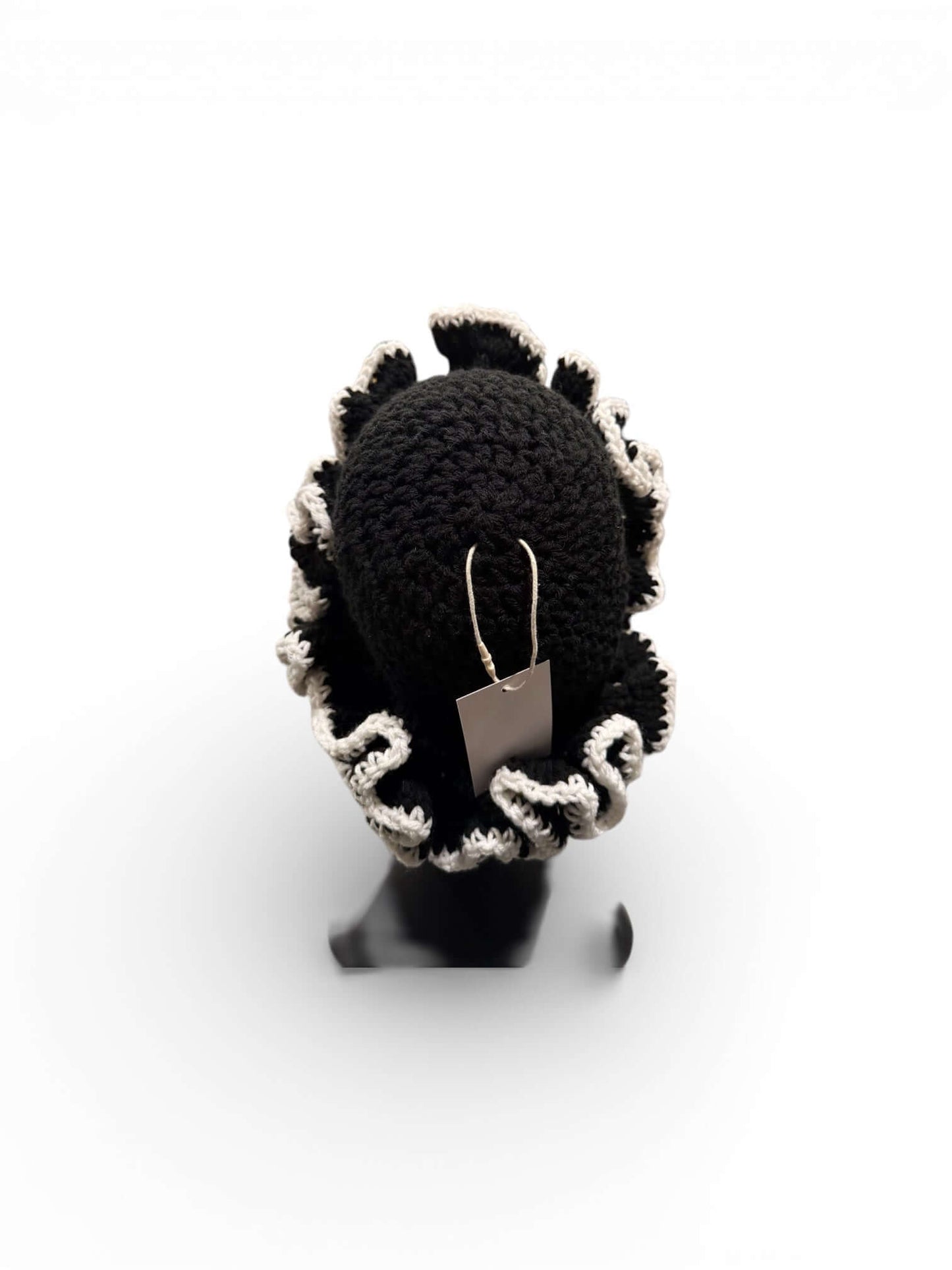 Monochrome Ruffle Crown-Signature Texture Crown showcasing layered black ruffles with a stylish tag.