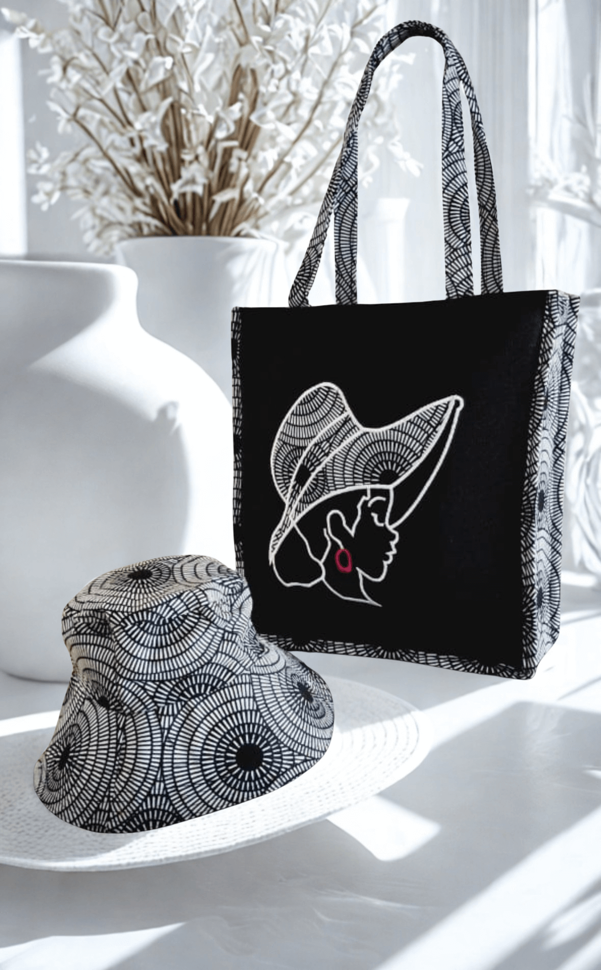 Mildred Multifunctional Hand Stitched Tote | Legacy Dealz Ancestry Collection next to a stylish hat.