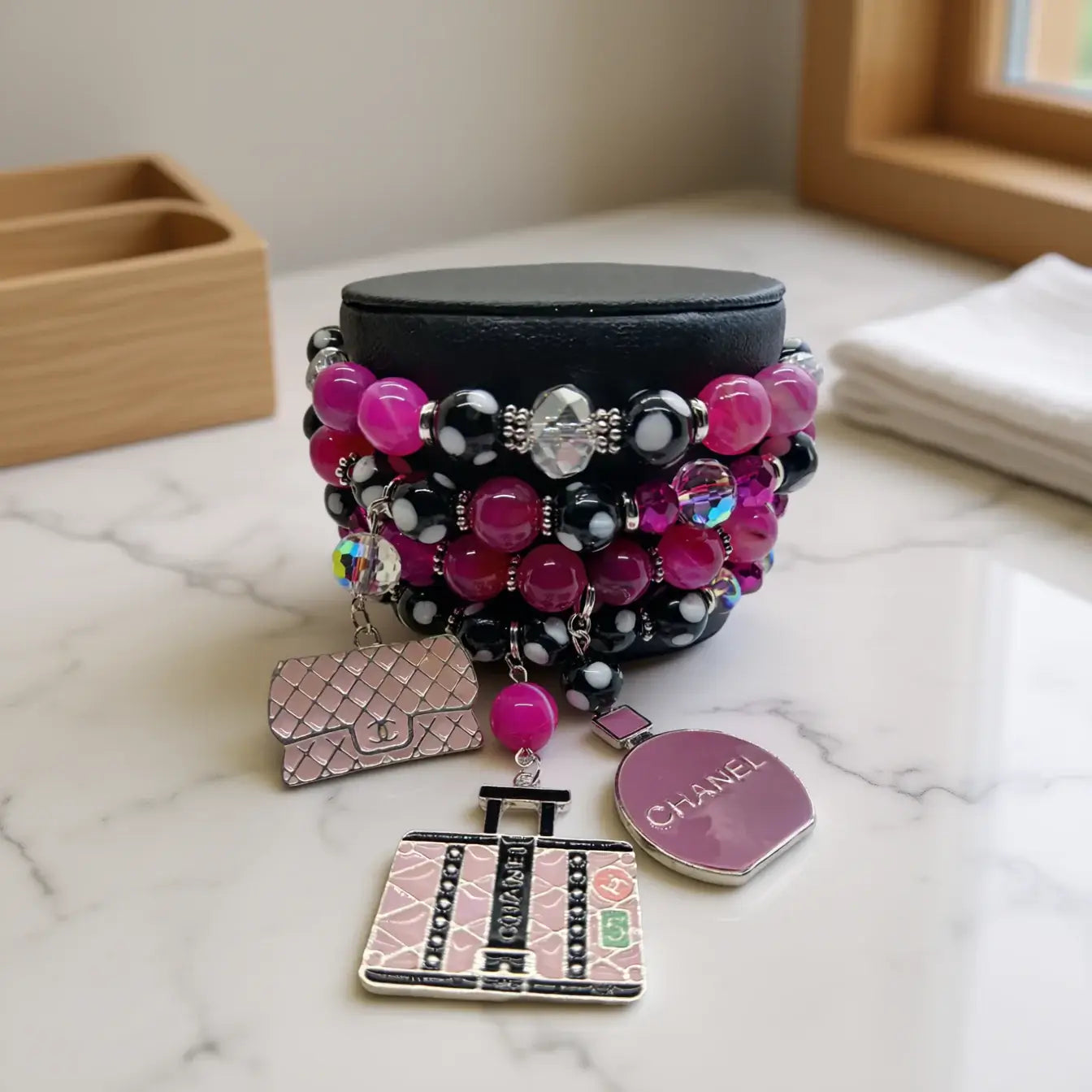 Legacy Pink Noir Duo Set – Handmade Fuchsia & Black Beaded Earrings + Charm Bracelet displayed on a stylish surface.