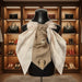 Cameo Couture Tie | Elegant Women’s Statement Accessory displayed elegantly on a mannequin in a luxurious closet.