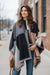 Model wearing the Monarch Colorblock Luxe Shawl Wrap – Soft Cashmere-Feel Poncho, showcasing its neutral colors and stylish design.