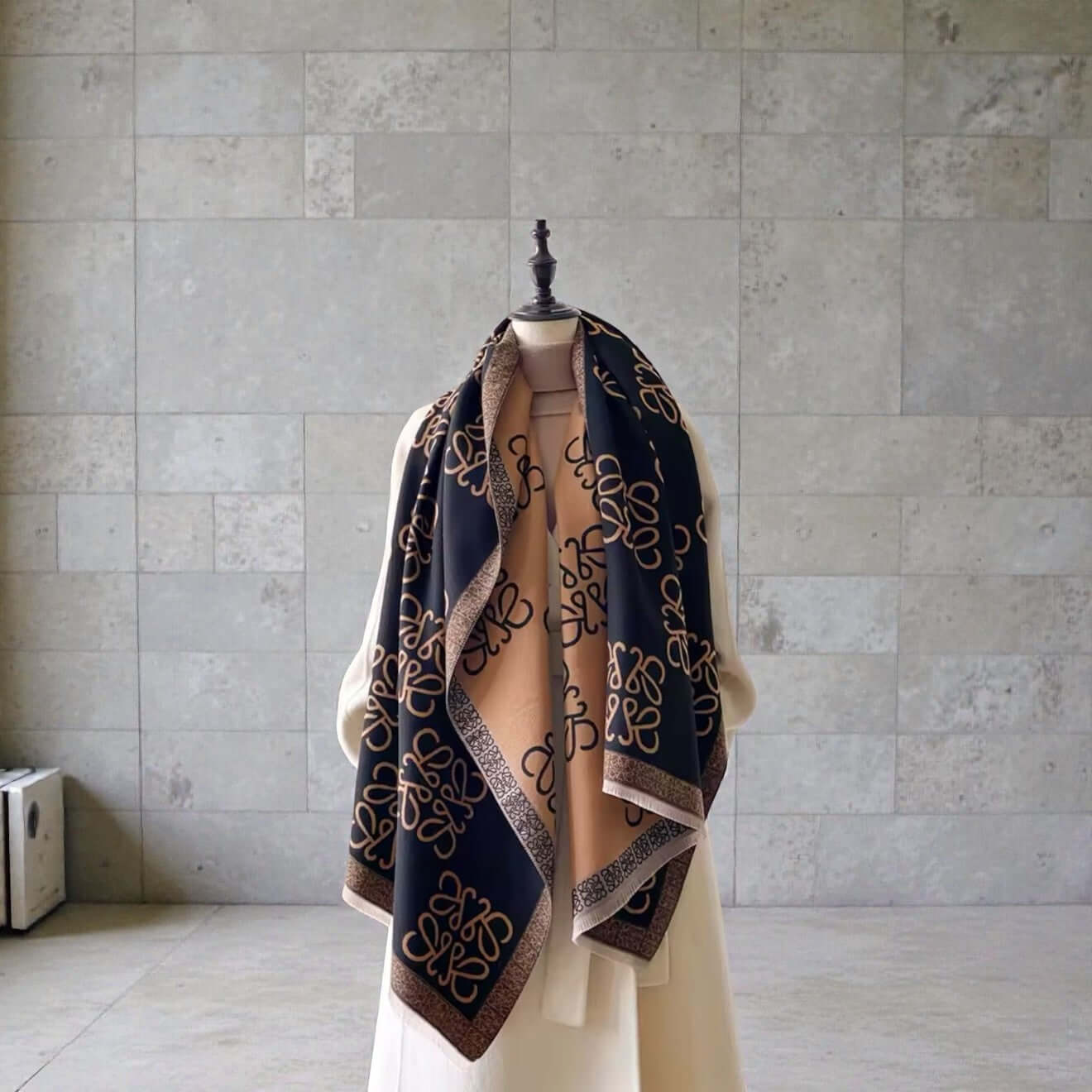 Legacy Luxe Signature Monogram Shawl – Brown or Black draped elegantly over a mannequin, showcasing its luxurious design.