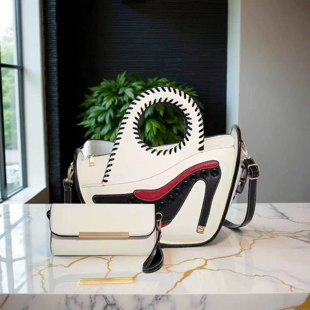 Shoe Lover Handbag And Wallet Set on a marble table, featuring unique circular cut-out handles and sleek design.