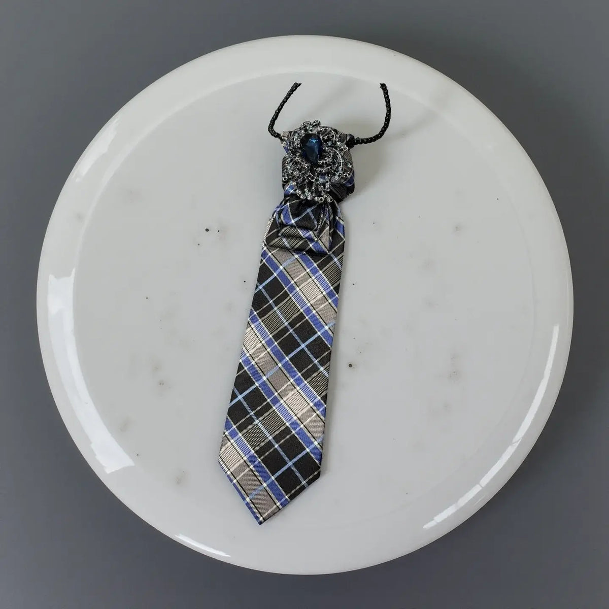 Sapphire Noir Statement Tie Necklace – Handcrafted One-of-One displayed on a white marble plate.