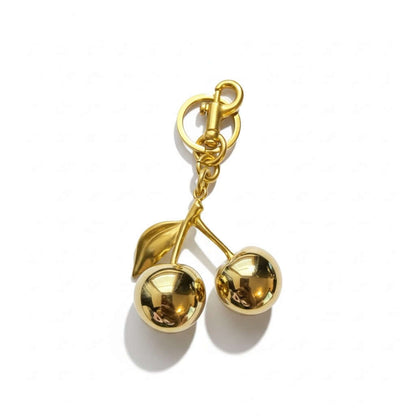Legacy Ruby Cherry Charm with glossy deep-ruby cherries and luxe gold detailing for handbags.