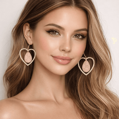 ✨ Blush Legacy Heart Earrings – One of One worn by a model, showcasing elegant gold-tone frame and blush heart drop.
