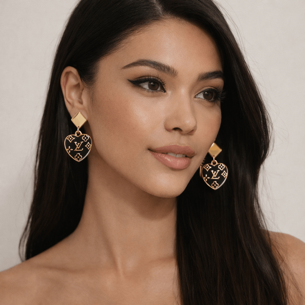 Noir Monogram Heart Drop Earrings (Upcycled • One of One) worn by a model showcasing their elegant design.