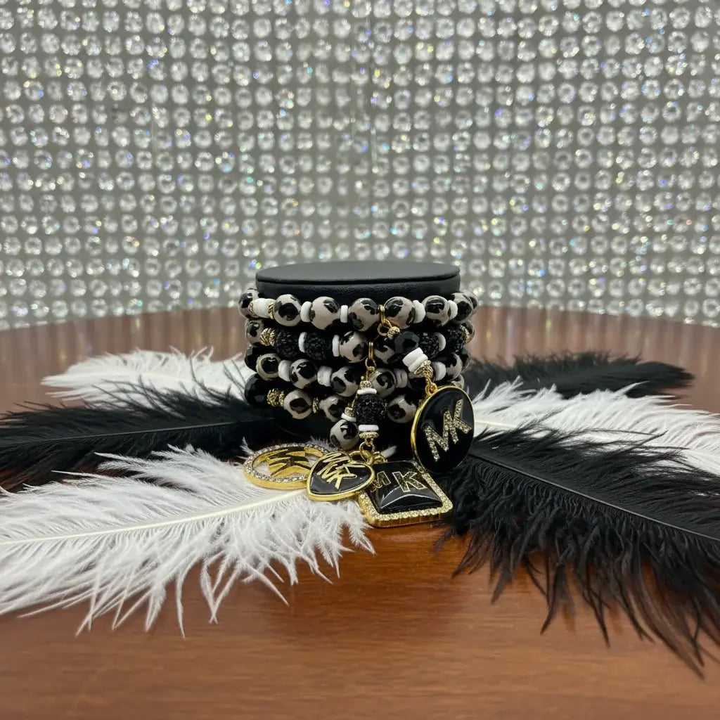 Legacy Ebony Ivory Duo Gem Set featuring a chic black-and-white bracelet with gold accents and statement charms.
