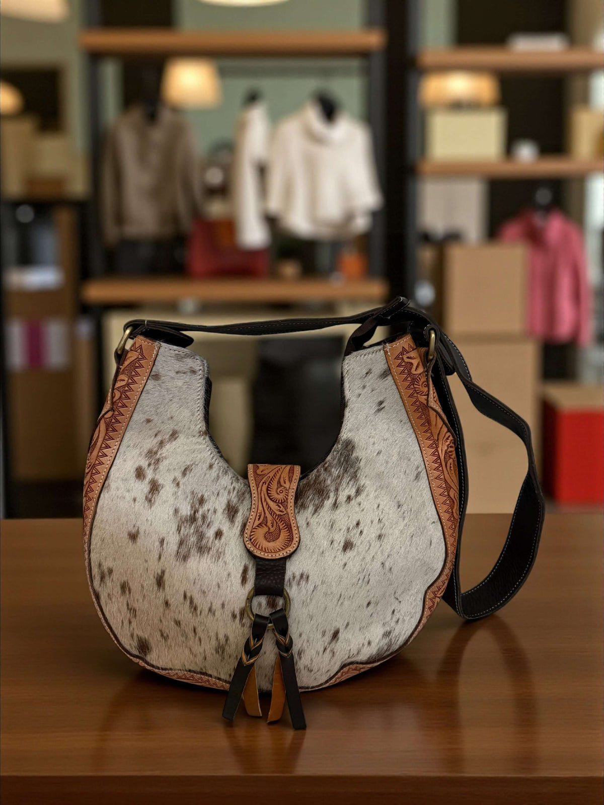 Saddle Luxe Cowhair Hobo Bag – Western Chic Handcrafted Purse displayed in a stylish boutique setting.