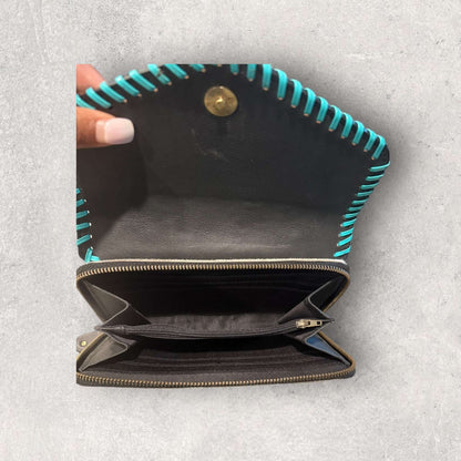 Interior view of the Saddle Bloom Cowhide Crossbody Wallet with turquoise whipstitch detailing.