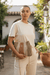 Model showcasing the Solara Handcrafted Crochet Chain Crossbody in a sunny outdoor setting.