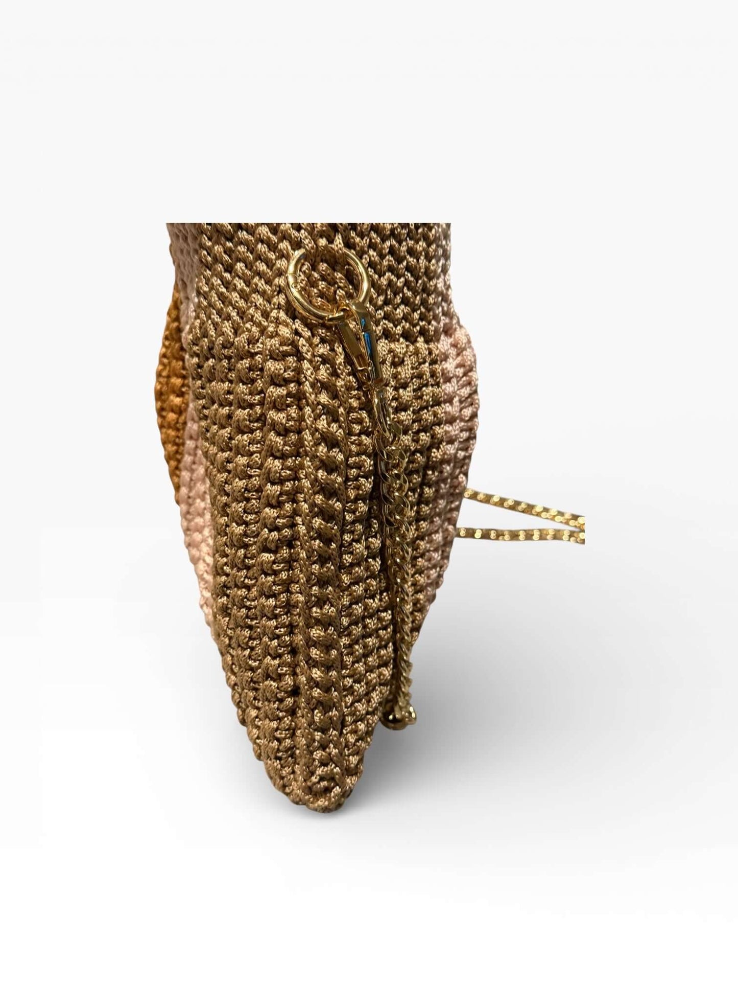 Side view of the Solara Handcrafted Crochet Chain Crossbody showcasing its unique crocheted texture and gold-tone zipper.