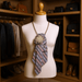 Champagne Rosette Statement Tie | One-of-One Handcrafted Luxury Accessory displayed on a mannequin in a stylish wardrobe.