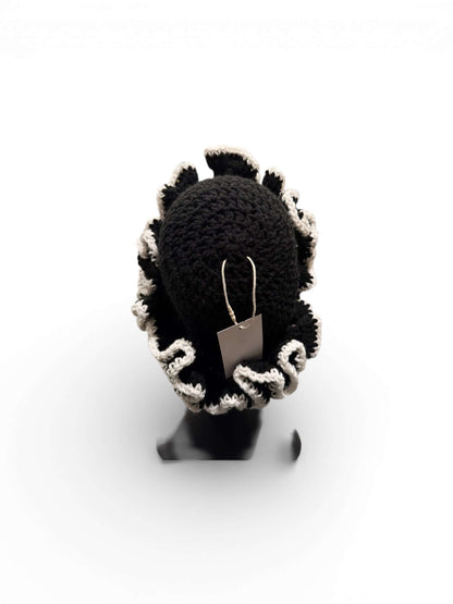 Monochrome Ruffle Crown-Signature Texture Crown showcasing layered black ruffles with a stylish tag.