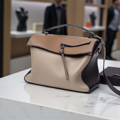 Sienna Grace Satchel | Legacy Dealz Handcrafted Leather Bag displayed on a marble surface showcasing its chic two-tone design.