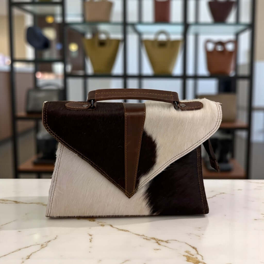 Trinity Luxe Hair-On Cowhide Leather Satchel – Custom Handmade Western Chic Handbag by Legacy Dealz on display.