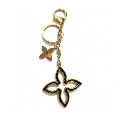 Legacy Noir Blossom Sparkle Charm featuring a gold and black design with chic detailing.