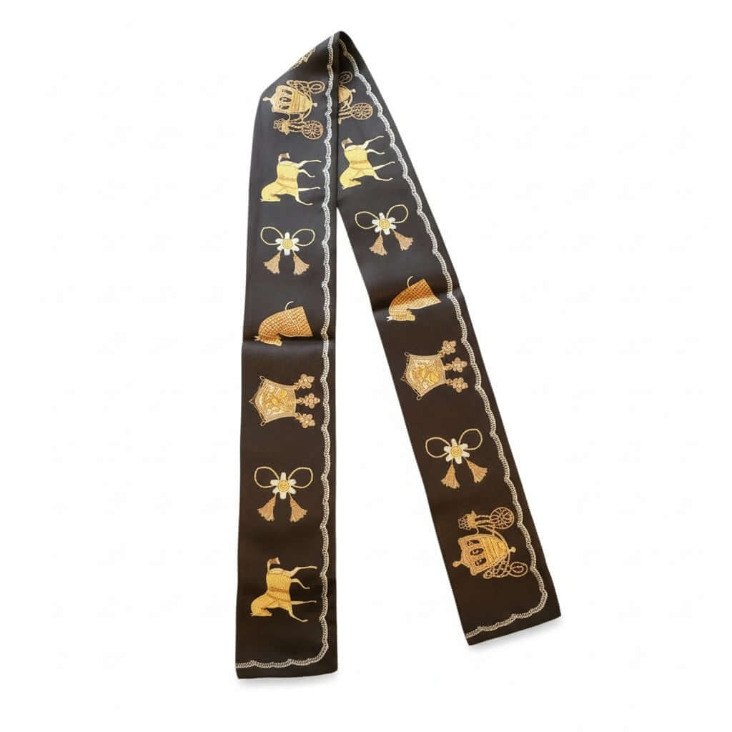 Legacy Royal Carriage Twilly featuring rich brown tones with gold motifs of carriages and horses.
