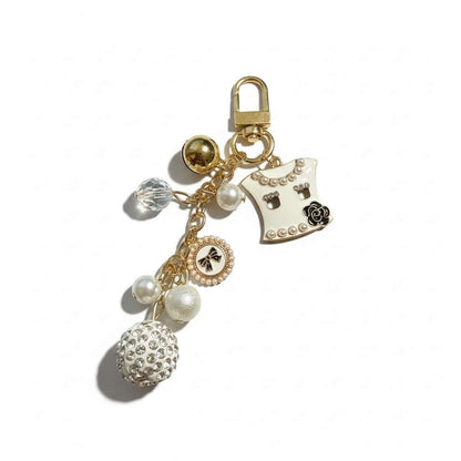 Legacy Pearl Couture Charm featuring creamy pearls, crystal accents, and a chic black bow for handbag elegance.