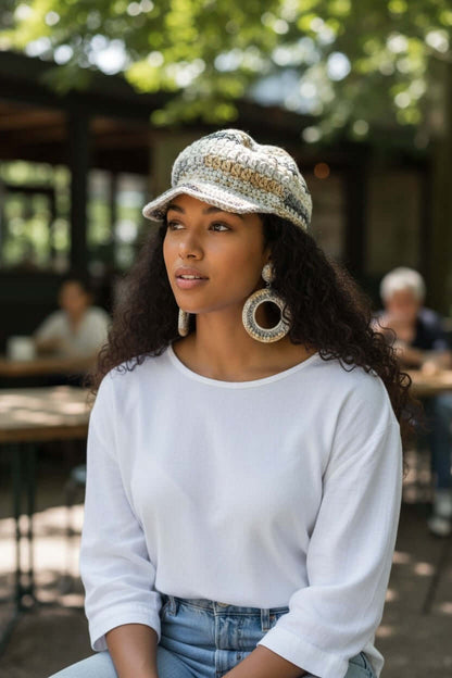 Model wearing the Signature Texture Crown Set -Heritage Loop - Handmade Artisan Style with a crocheted cap and earrings.