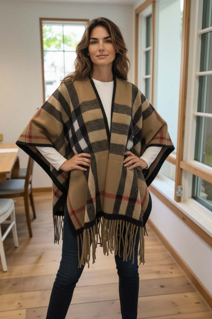 Model wearing a Heritage Plaid Luxe Poncho Shawl – One Size Cozy Fringe Wrap in a stylish indoor setting.