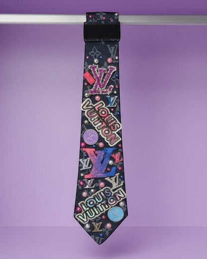 Legacy Dealz black tie with colorful logos, pearls, and glitter accents. Unique statement accessory.