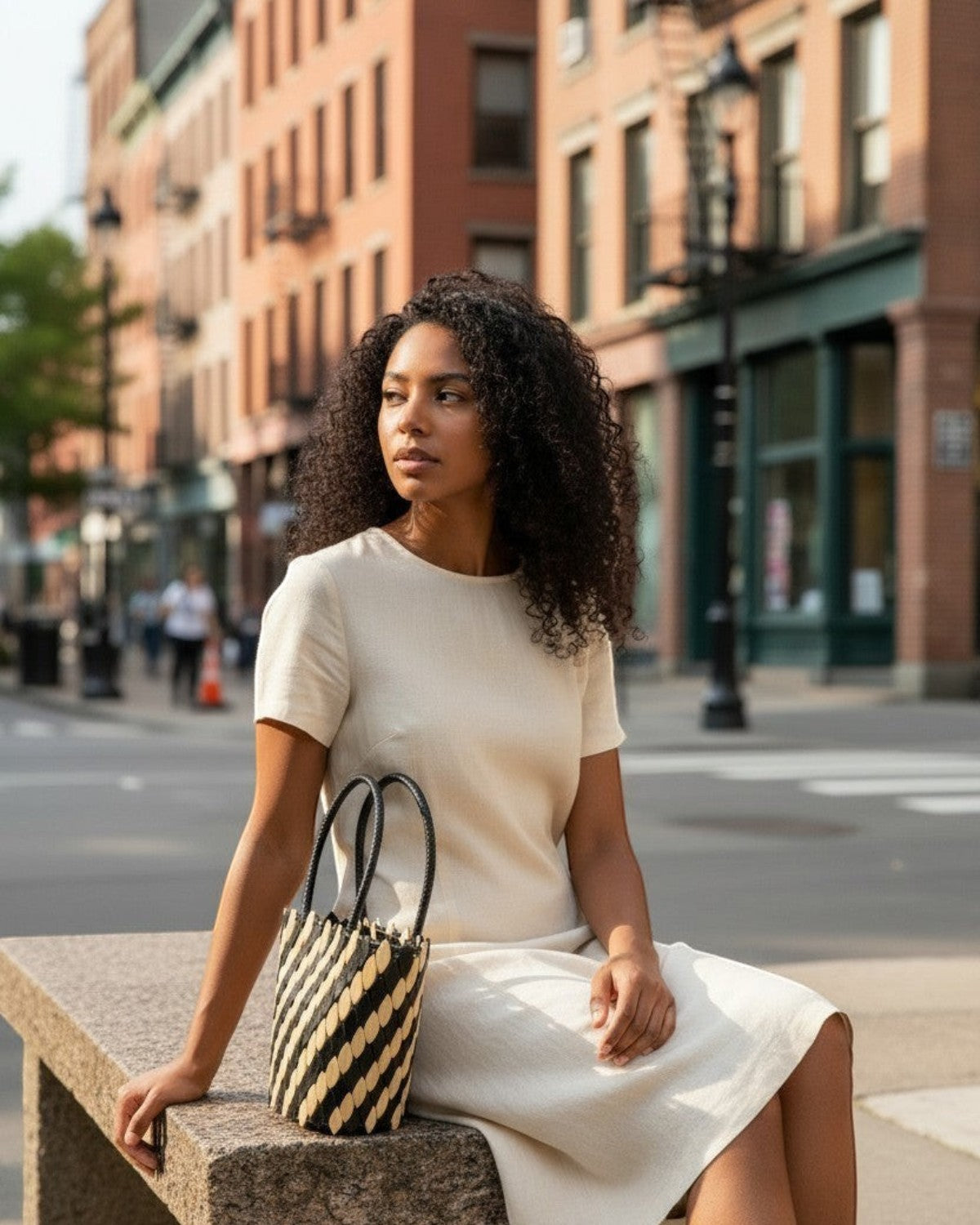 Legacy Dealz Annie black and cream handcrafted leather and wood bucket tote bag with diagonal stripe pattern.