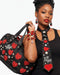 Legacy Dealz black quilted duffel bag with red heart appliques, pearls, and 