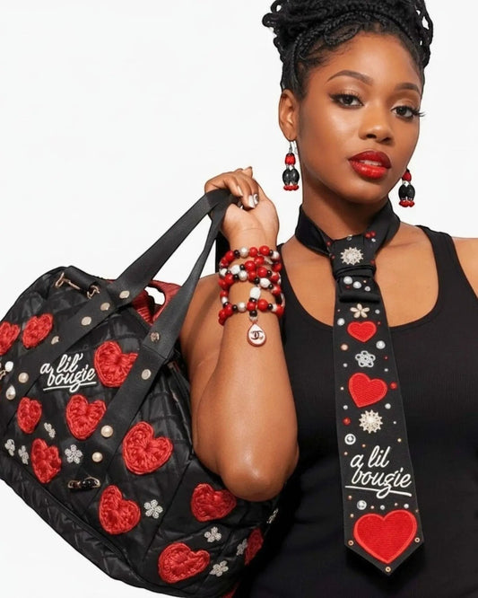 Legacy Dealz black quilted duffel bag with red heart appliques, pearls, and "a lil bougie" script. Matching tie included.