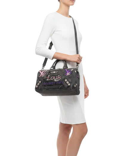 Legacy Dealz charcoal denim duffel bag and tie set with purple, pink, and blue logos and crystal accents.