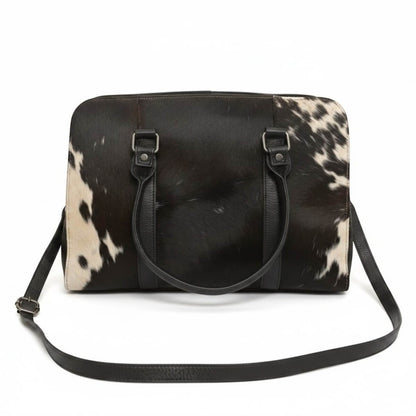 Legacy Dealz Wyatt Bow Bag: black and white cowhide leather crossbody with top handles and detachable strap.