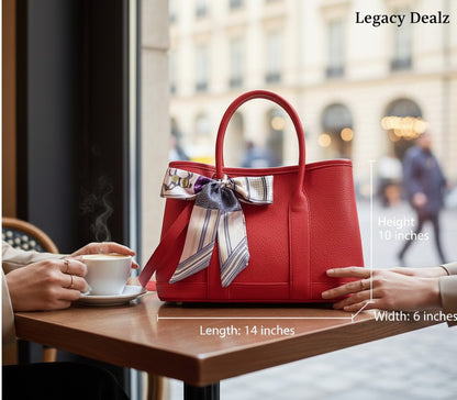 Legacy Luxe red leather-like tote bag with a silk scarf bow detail and double handles, perfect for statement carry.